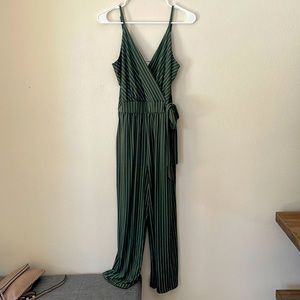 Olive color jumpsuit with white stripes.